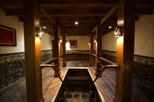 a walkway in a building with wooden floors and lights at The Sea Cliff Hotel Resort & Spa in Port Antonio