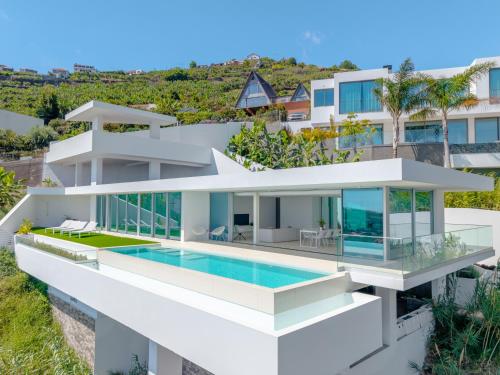 an aerial view of a white house with a swimming pool at Villa Gia in Calheta