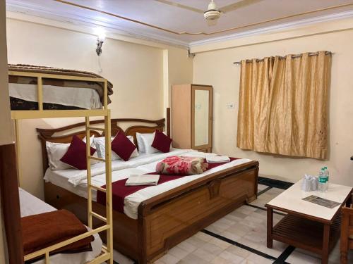 a bedroom with two bunk beds and a table at Hotel Vijay Niwas in Jaipur