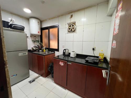 a small kitchen with a sink and a refrigerator at Universe Holiday Homes in Dubai
