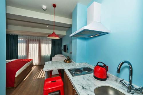 a kitchen with a sink and a room with a bed at Taksim Istanbul Nis Hotel - Istiklal Street in Istanbul