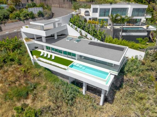 an aerial view of a house with a swimming pool at Villa Gia in Calheta