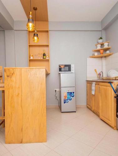 a kitchen with a refrigerator and a counter top at River point inn in Arusha