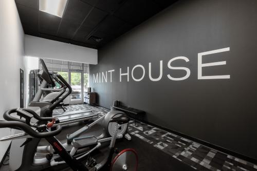 a gym with two tread machines and a unit house at Mint House Greenville Downtown By Kasa in Greenville