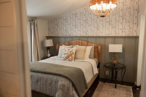 a bedroom with a bed and a chandelier at The Cottage at Cardinal Hill in Dahlonega