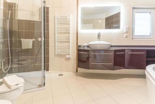 a bathroom with a sink toilet and a shower at Villa Atlantica in Setúbal