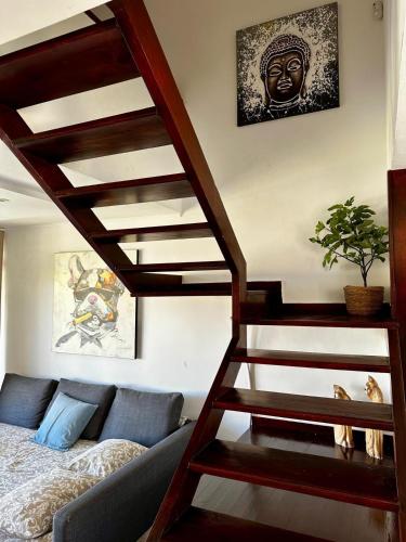 a living room with a staircase and a couch at Amazing duplex Las Americas in Costa de Adeje