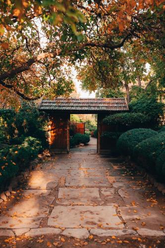 a stone walkway with a bridge in a garden at Deluxe Himeji 2 Bedrooms Apartment in Adelaide