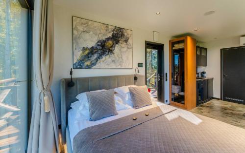 a bedroom with a bed with a large painting on the wall at Luxury Resort Kabuna in Kabuna