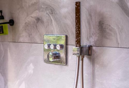 a metalswitch on the wall of a bathroom at Luxury Resort Kabuna in Kabuna
