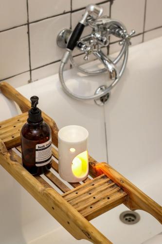 a bottle of honey and a candle on a bathroom sink at Palm La Vie in Worcester