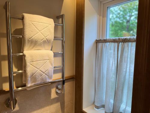 a towel rack in a bathroom with a window at Åkerblads Hotell Gästgiveri Spa in Tällberg