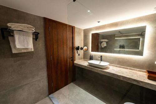 a bathroom with a sink and a mirror at Garrya Romo Hotel in Urla