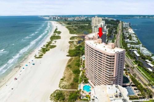 an aerial view of a beach with a tall building at Crescent Beach Club I 12D in Clearwater Beach