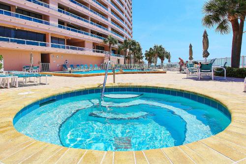 a large swimming pool with blue water in front of a building at Crescent Beach Club I 12D in Clearwater Beach