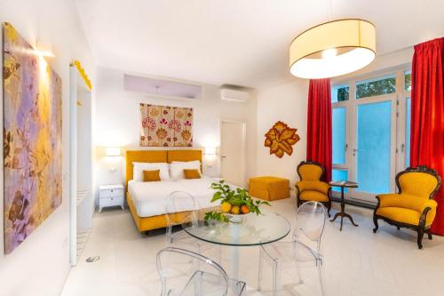 a bedroom with a bed and a table and chairs at Dimora Filangieri in Massa Lubrense