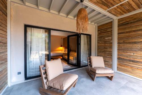 two chairs sitting on a porch with a bedroom at Garrya Romo Hotel in Urla