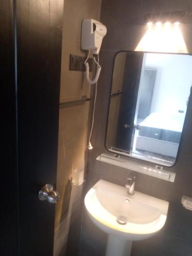 a bathroom with a sink and a mirror at Arhh castle in Ginigathena