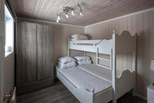 a bedroom with two bunk beds in a room at Skoglund privat Villa in Trysil