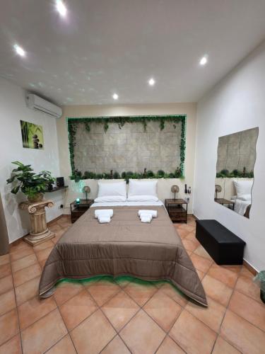 a bedroom with a large bed in a room at Monreale Prestige Rooms B&B in Monreale