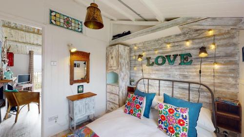a bedroom with a bed and a wooden wall at E41 Silver Mist, Riviere Towans in Hayle