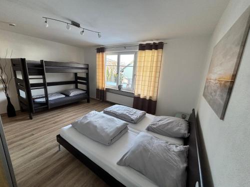 a bedroom with two beds and a bunk bed at Mood4 in Burgau