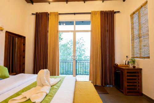 a bedroom with a bed and a large window at AnuBi Nest Ella in Ella