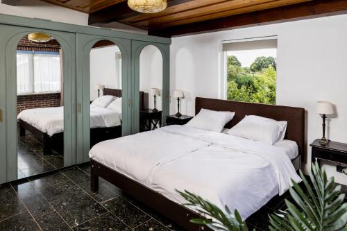 a bedroom with two beds and two windows at Bij nr 5 Teuge in Terwolde