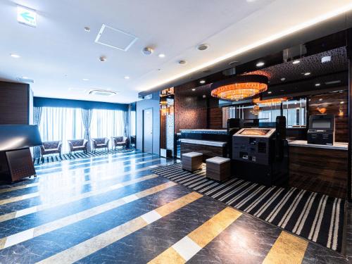 a hotel lobby with a pool table and a casino at APA Hotel Himeji Ekikita in Himeji