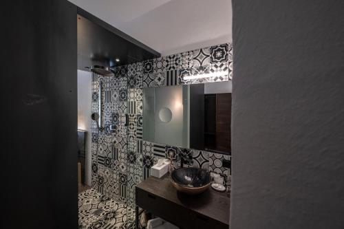 a bathroom with a sink and a mirror at flurin Suites in Glorenza
