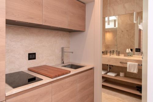 a bathroom with a sink and a counter top at Suite Apartments by Hotel Gabbani in Lugano