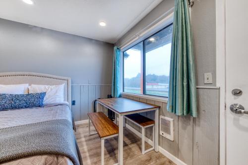 a small bedroom with a bed and a window at Sea Treasures Inn #104 in Rockaway Beach