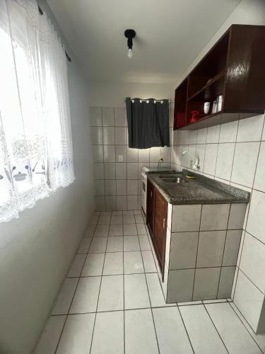 a small kitchen with a sink and a window at Hotel e Pousada Recanto do mar in Florianópolis