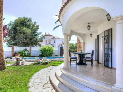 a patio with a table and chairs next to a pool at Villa Villa Mar by Interhome in Miami Platja