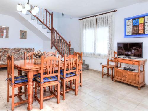 a dining room with a wooden table and chairs at Villa Villa Mar by Interhome in Miami Platja