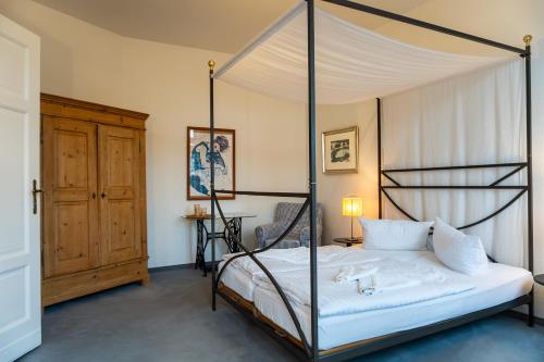 a bedroom with a four poster bed with a canopy at Villa Cremona in Bansin