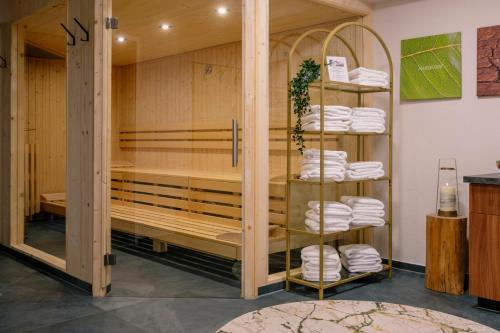 a room with a sauna with a rack of towels at Alpine B&B including summercard in Plangeross