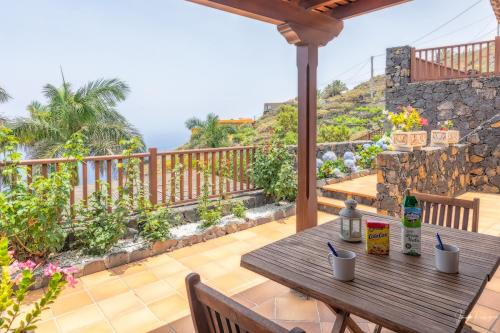 a wooden table on the deck of a house at Guestready - La Morita Villa de Mazo in Mazo