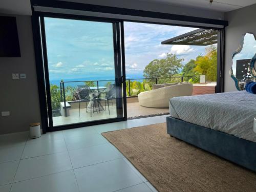 a bedroom with a bed and a view of the ocean at La Font Ecolodge in Buenavista