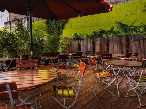 an outdoor patio with tables and chairs at Ballhaus Berlin Hostel in Berlin