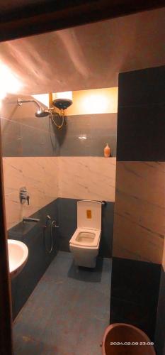 a bathroom with a toilet and a sink at THE Temple View ''Near Kashi Vishwanath'' in Varanasi