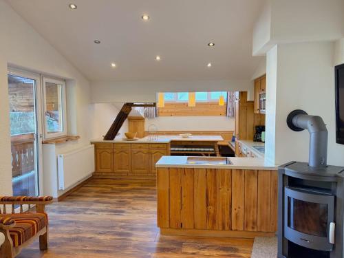 a large kitchen with wooden cabinets and a stove at Apartment Daniel by Interhome in Hollersbach im Pinzgau
