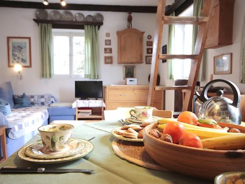 a room with a table with a bowl of fruit on it at Chalet Hüttl by Interhome in Trins