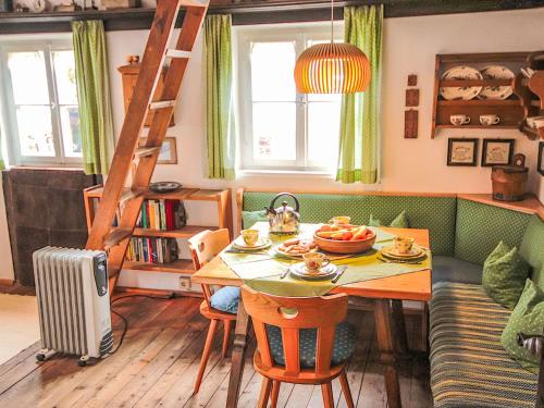 a living room with a table and a couch at Chalet Hüttl by Interhome in Trins