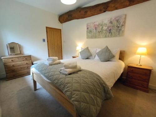 a bedroom with a bed with two pillows on it at Farm Stay with animal experiences, 30 minutes to Exmoor & Beaches, Pet friendly, Outdoor heated pool, Games barn, fast WiFi and parking in Barnstaple