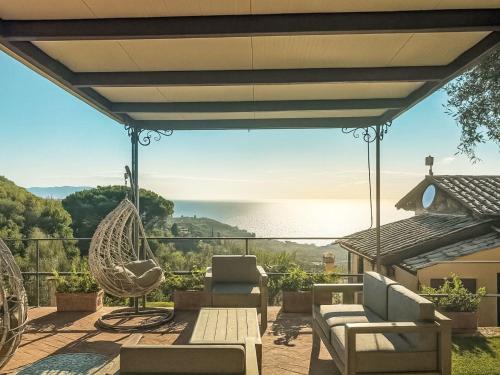 a patio with a hammock and a view of the water at Villa Ricali by Interhome in Porto Santo Stefano