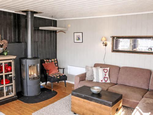 a living room with a couch and a wood stove at Holiday Home Evabu by Interhome in Øyuvstad