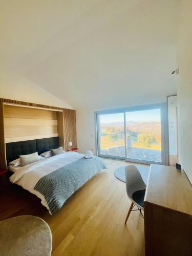 a bedroom with a large bed and a large window at passa tempo Boutique Hideaway in Montefano