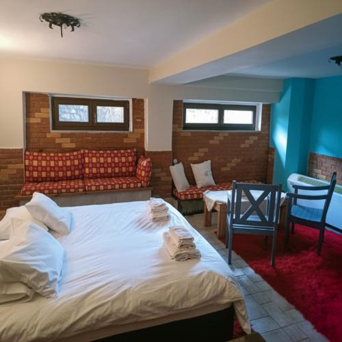 a bedroom with a large white bed and a couch at Amadrias Villa Florina in Florina