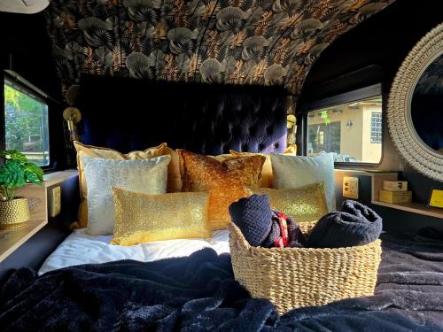 a bedroom with a bed with a blanket and pillows at Tin Town Glamping in Haenertsburg
